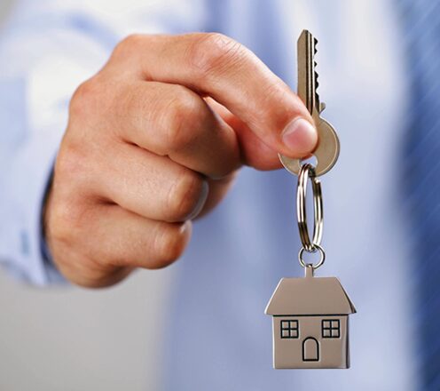 A person holding keys to a house